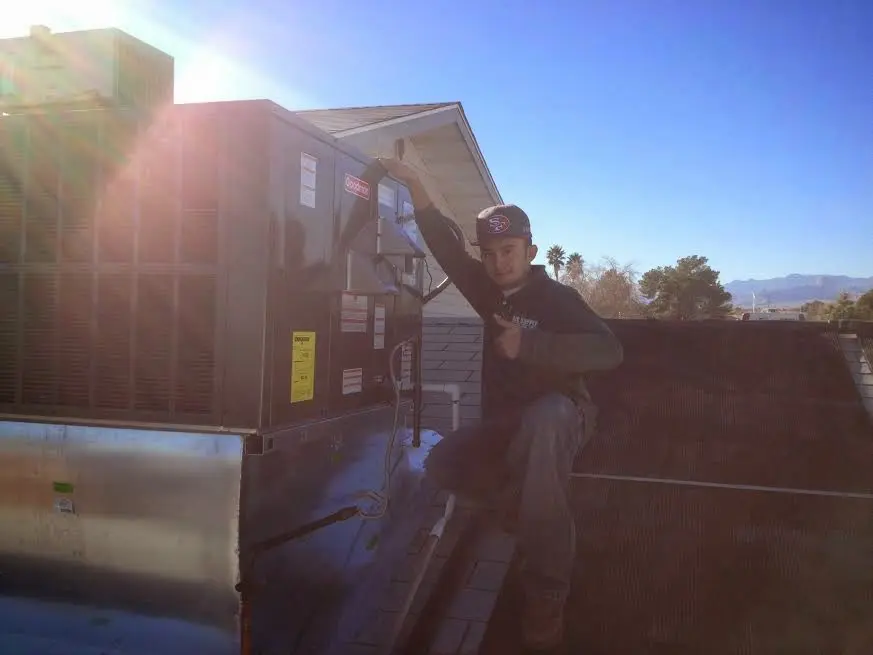 HVAC technician performing HVAC Inspection on a rooftop unit in New Hyde Park